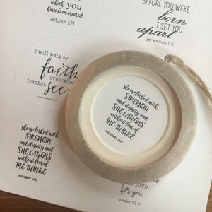 May include: A set of six round, white paper stickers with black text. Each sticker features a different Bible verse. The verses are: Act justly, love mercy, walk humbly Micah 6:8; When you go through deep waters I will be with you Isaiah 43:2; Perhaps this is the moment for which you have been created Esther 4:14; Before you were born I set you apart Jeremiah 1:5; I will walk by faith even when I cannot see 2 Corinthians 5:7; She is clothed with strength and dignity and she laughs without fear of the future Proverbs 31:25.