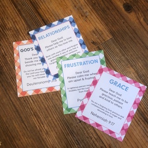 May include: Four colorful cards with a checkered pattern and inspirational messages for different situations. The cards include the words "God's", "Relationships", "Frustration", and "Grace". Each card has a Bible verse at the bottom.