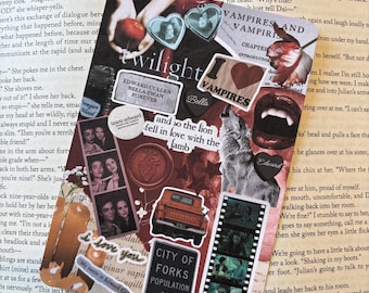 May include: A decorative bookmark featuring a collage of images and text related to the Twilight saga. Includes images of the characters, quotes, and the words "Twilight," "Vampires," and "City of Forks." The bookmark is placed on an open book.