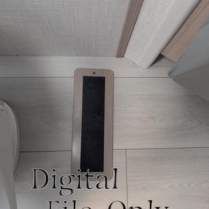 May include: A rectangular, beige-colored vent cover with a black, textured center is positioned vertically on a light-colored wooden floor. The text "Digital File Only" is displayed in a stylized font below the vent.