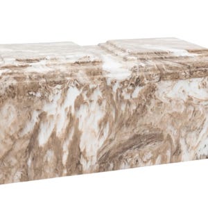 May include: A white and brown marble cremation urn with a rectangular shape.