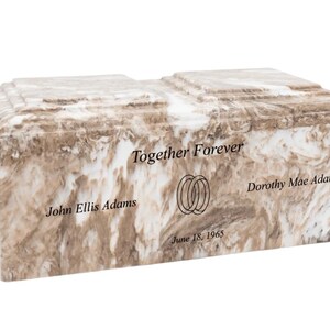 May include: A white and brown marble cremation urn with the inscription "Together Forever" and the names "John Ellis Adams" and "Dorothy Mae Adams" along with the date "June 18, 1965".