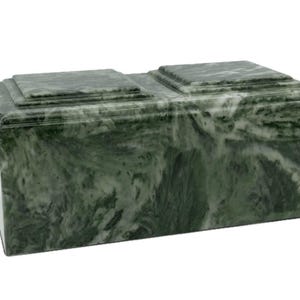 May include: A green marble cremation urn with a double-lid design. The urn has a swirling pattern of green and white.