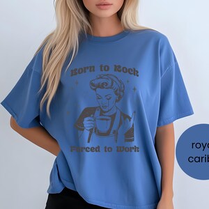 May include: A royal blue oversized t-shirt with a graphic of a woman holding a cup of coffee and the text "Born to Rock, Forced to Work".