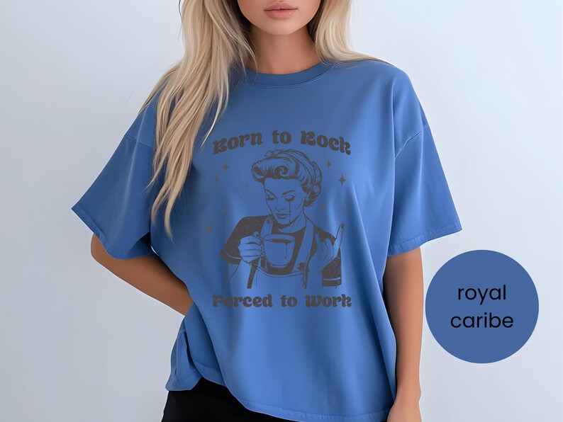 May include: A royal blue oversized t-shirt with a graphic of a woman holding a cup of coffee and the text "Born to Rock, Forced to Work".