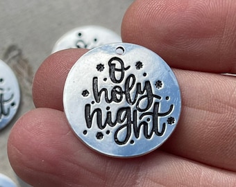 May include: Silver metal charm with the words "O holy night" in black lettering. The charm is decorated with small stars.