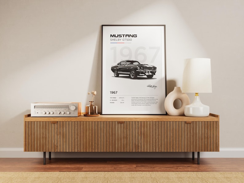 May include: A black and white poster of a 1967 Ford Mustang Shelby GT500 with the text "Mustang Shelby GT500 1967" on a wooden shelf with a stereo and a lamp.