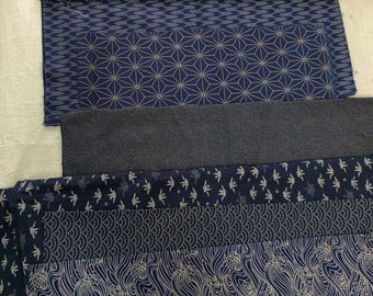 May include: Five different fabric swatches in shades of blue with white patterns. The patterns include a geometric design, a wave pattern, a bird pattern, and a dragon pattern.