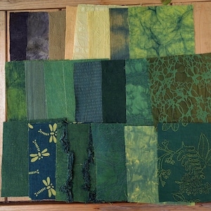 May include: A patchwork quilt made of various shades of green fabric squares. Some squares have a subtle pattern, while others are solid.