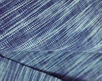 May include: Close-up of a blue and white textured fabric with a subtle striped pattern.