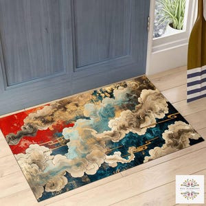May include: Rectangular doormat with a cloud design in shades of red, gold, blue, and grey. The mat features an Asian-inspired aesthetic, with swirling cloud patterns and decorative lines. The mat is placed in front of a blue door.