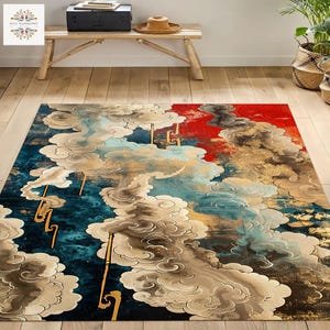 May include: A rectangular rug with a cloud design in shades of blue, gold, red, and cream. The rug features a detailed pattern of stylized clouds and gold accents. The rug is placed on a wooden floor.