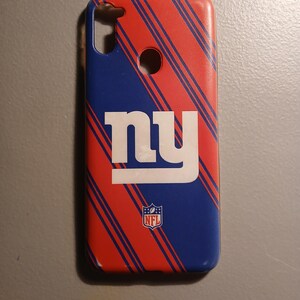 May include: A red and blue phone case with diagonal stripes and the New York Giants logo. The logo is white with the letters "NY" and an NFL logo.