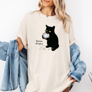 Camiseta vintage de gato, unisex, blanca, divertida, con coco, con felino hambriento, colores cómodos.