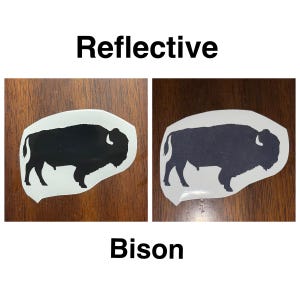 May include: Two images of a black bison silhouette on a white background. The image on the left is a standard image, while the image on the right is reflective. The text "Reflective" is above the images and the text "Bison" is below the images.