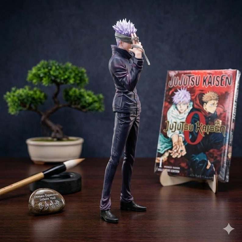 May include: A figurine of a character with spiky purple hair and a blindfold, dressed in a dark outfit, stands next to a manga volume titled "Jujutsu Kaisen." A bonsai tree and calligraphy tools are also visible.