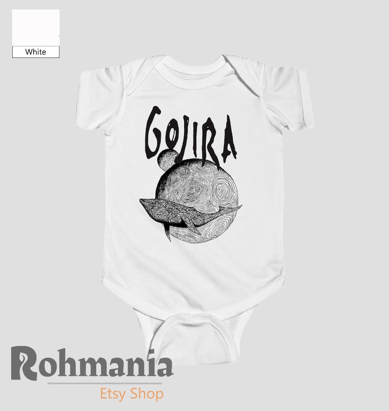 May include: White baby bodysuit with a black graphic. The design features the word "GOJIRA" above a detailed illustration of a whale swimming in front of a textured sphere. The bodysuit is a one-piece garment.