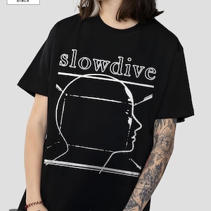 May include: Black t-shirt with the band name "slowdive" in white, and a white outline of a head. The t-shirt has a crew neck and short sleeves.