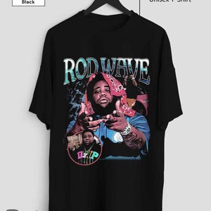 May include: Black unisex t-shirt with a vintage-style graphic of Rod Wave, a rapper, wearing a bandana and a gold chain. The graphic includes the text "Rod Wave" in a colorful font.
