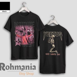May include: Black t-shirt with a retro graphic of Kanye West and the text "Kanye West" on the front. The back of the shirt features "YEEZUS" above a kneeling skeleton and the text "GOD WANTS YOU".