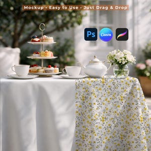 May include: A white tablecloth with a floral patterned runner hosts a tiered dessert stand, teacups, a teapot, and a vase of white flowers. The scene is set outdoors with the text "Mockup - Easy to Use - Just Drag & Drop".