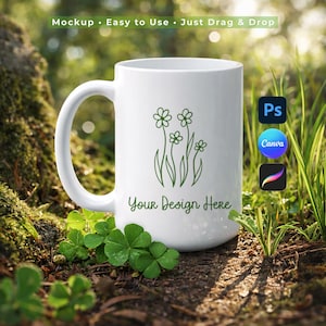 May include: A white ceramic mug with a green floral design and the text "Your Design Here." The mug has a large handle and is set against a natural background with greenery. The text "Mockup • Easy to Use • Just Drag & Drop" is at the top.
