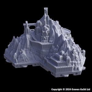 May include: A gray, 3D-printed miniature fantasy mountain terrain with a castle, bridge, and tower. The detailed model features multiple levels, trees, and architectural elements, perfect for tabletop gaming or display.