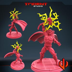 May include: Pink figurine of a superhero with a red cape, holding a hammer and surrounded by yellow lightning. The figurine is on a round, textured base. The Trident Studio logo is at the top.