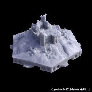 May include: A miniature castle model with a stone facade, featuring a central tower, multiple turrets, and a winding pathway. The model is set on a hexagonal base with a textured surface, and small trees. The color is a light gray.