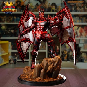 May include: A black and red action figure of a superhero with large wings, standing on a rocky base. The figure has a bat-shaped symbol on its chest and a helmet with pointed ears. The wings are detailed with a geometric pattern. The figure is a 3D printing design.