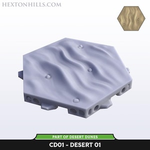 May include: Hexagonal terrain piece with a desert dune design. The light gray piece has a textured surface with flowing lines and small, raised details. The base has several circular holes and the text "CD01 - DESERT 01".