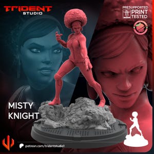 May include: A red 3D-printed figurine of Misty Knight, posed on a rocky base. The figure is wearing a form-fitting outfit and has an afro hairstyle. The base is on a round platform. The Trident Studio logo and "Misty Knight" text are visible.