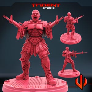 May include: A red 3D-printed figurine of a warrior with two rifles, standing on a circular base. The figurine is in a battle stance, with an open mouth. Two smaller figurines are also shown. The Trident Studio logo is at the top.