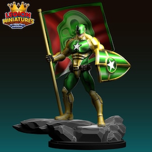 Könnte beinhalten: Eine 3D-gedruckte Superheldenfigur in grüner und goldener Rüstung, die eine Flagge und einen Schild hält. Die Figur steht auf einem felsigen Sockel. Die Flagge ist rot und grün. Der Schild hat einen weißen Stern.
