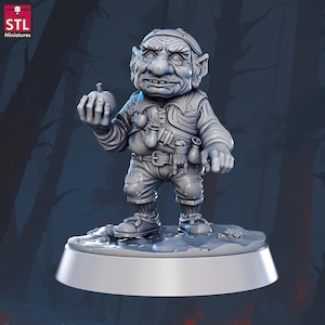 May include: A gray miniature figurine of a goblin holding an apple. The goblin is wearing a tunic, pants, and a belt with pouches. The figurine is on a round base. The logo "STL Miniatures" is in the top left corner.