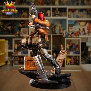 May include: A detailed figurine of a character in a red helmet and brown jacket, holding two guns. The figure is posed dynamically on a black base with a wooden crate and debris. The logo "LEGION MINIATURES 3D PRINTING DESIGNS" is visible.