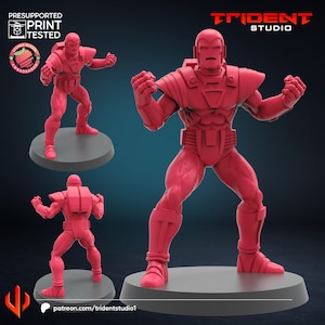 May include: A red 3D-printed figurine of a superhero in a dynamic pose, with arms raised and fists clenched. The figure is on a grey circular base. The image includes the Trident Studio logo and text indicating it is presupported and print tested.
