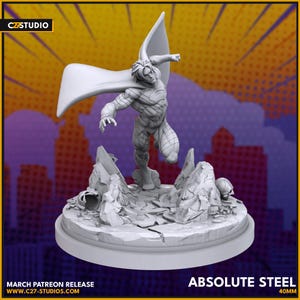 May include: A gray figurine of a superhero in a dynamic pose, with a flowing cape. The figure is leaping from a rocky terrain base. The text "ABSOLUTE STEEL 40mm" is at the bottom, along with "MARCH PATREON RELEASE" and a website address.