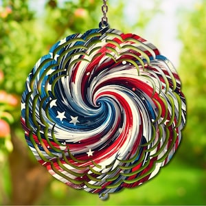 May include: A round, layered wind spinner with a patriotic design. The center features a spiral of red, white, and blue stripes with white stars. The outer edge has a green, scalloped trim, and it hangs from a silver chain.