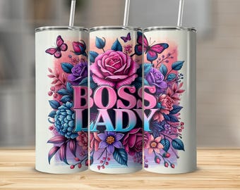 May include: A white tumbler with a floral design featuring pink roses, purple and blue flowers, and butterflies. The words "BOSS LADY" are displayed in a gradient font. The tumbler has a white straw.
