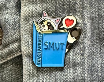Smut Reading Raccoon Enamel Pin – Spicy Book Lover Accessory
