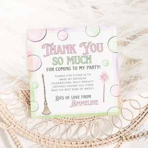 May include: A square card with pastel colors and the text "Thank You So Much For Coming To My Party!". The card includes illustrations of a broom and a magic wand. The text also says "Lots of Love From Emmeline".