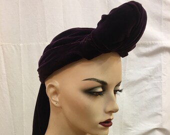 1930s, size 22, burgundy velvet cloche, with stuffed pompadour in fron