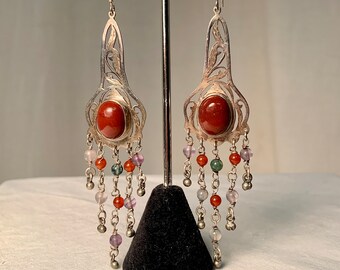 1990s 2 inch long earrings cut out silver tops, carnelian cabochon center stone.