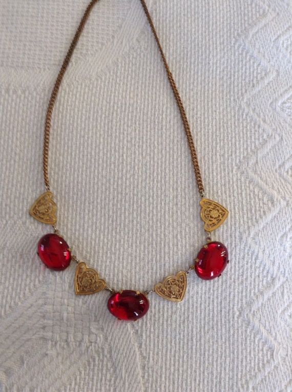 Red glass cabochon stones and 4 gold tone filigree