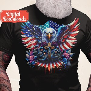 May include: A black t-shirt with a graphic of an American bald eagle with its wings spread wide, holding a cross. The eagle is superimposed over an American flag. Five police officers are standing in front of the eagle, holding guns and wearing blue uniforms. The graphic is surrounded by red, white, and blue flowers.