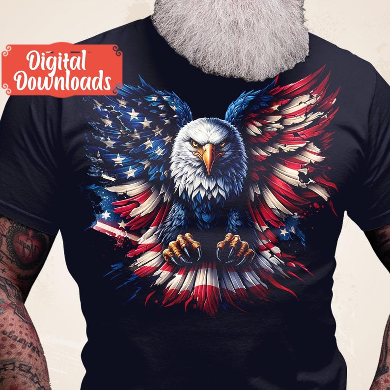 May include: A dark blue t-shirt with a graphic of a bald eagle with its wings spread out in the shape of the American flag. The eagle is white and gray with red, white, and blue feathers.