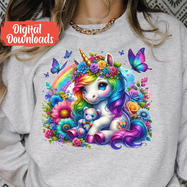 May include: A colourful rainbow unicorn with a flower crown and a teddy bear. The unicorn is surrounded by flowers and butterflies.