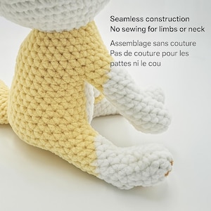 Pu&ograve; includere: Un animale di peluche fatto a mano, all'uncinetto in giallo e bianco. Il giocattolo ha una costruzione senza cuciture, senza cuciture per gli arti o il collo. Il testo sull'immagine dice: "Seamless construction, No sewing for limbs or neck, Assemblage sans couture, Pas de couture pour les pattes ni le cou."