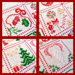 May include: A close-up of a cross-stitch sampler with four squares, each featuring a different Christmas-themed design. The designs include mittens, candy canes, Christmas trees, and hearts, all in red, green, and white.